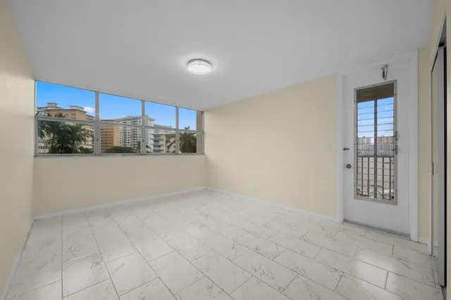 a view of a kitchen with a sink and a refrigerator