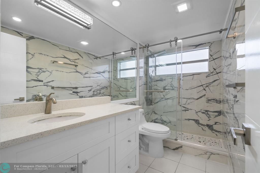 100 Golden Isles Drive, Unit 313 Hallandale Beach, FL 33009 - Photo 10 of 33 a bathroom with a sink toilet and shower