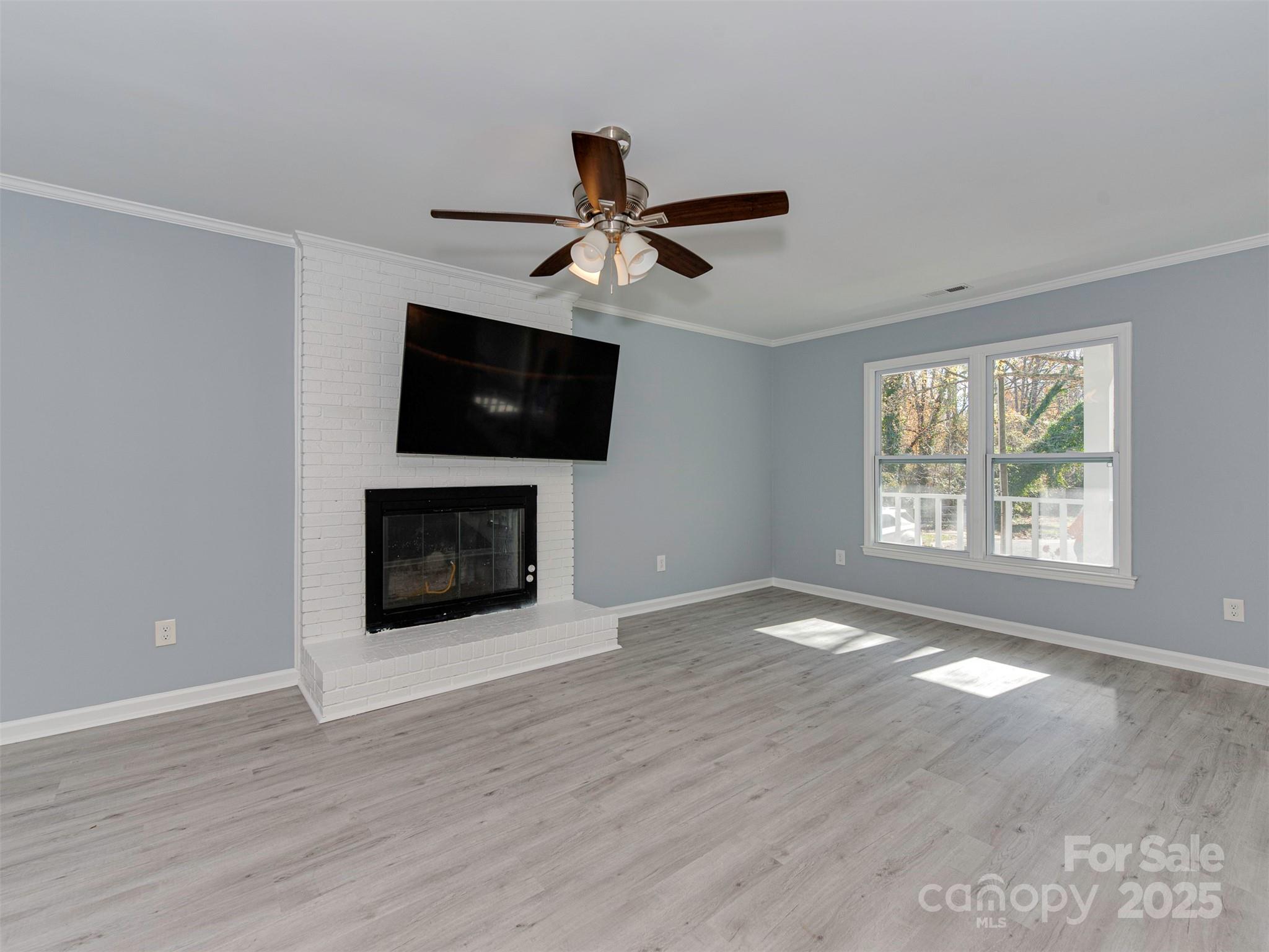 7413 Lockmont Drive Charlotte, NC 28212 - Photo 11 of 42 a view of empty room with a fireplace and a window