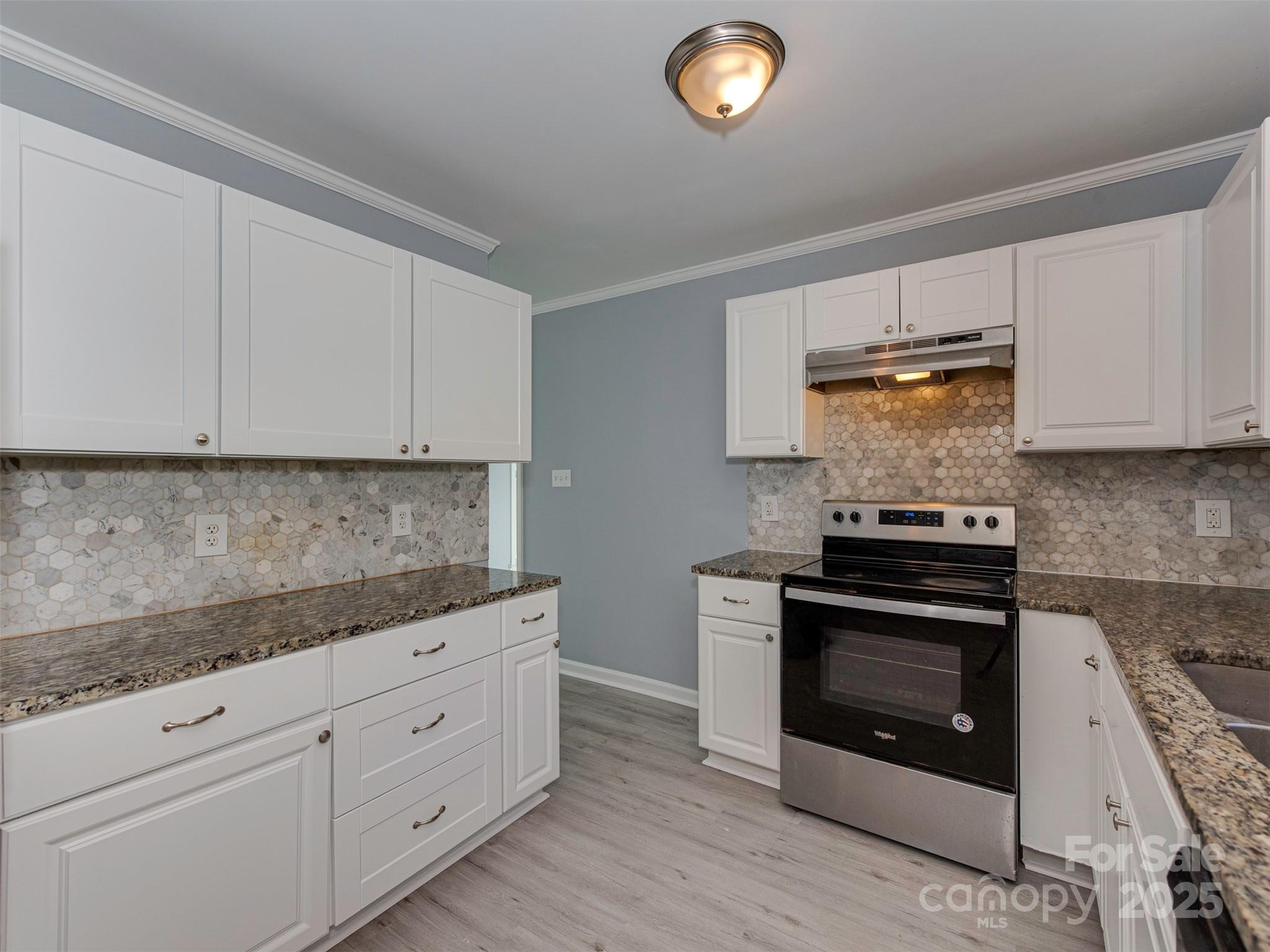 7413 Lockmont Drive Charlotte, NC 28212 - Photo 15 of 42 a kitchen with granite countertop white cabinets and white appliances