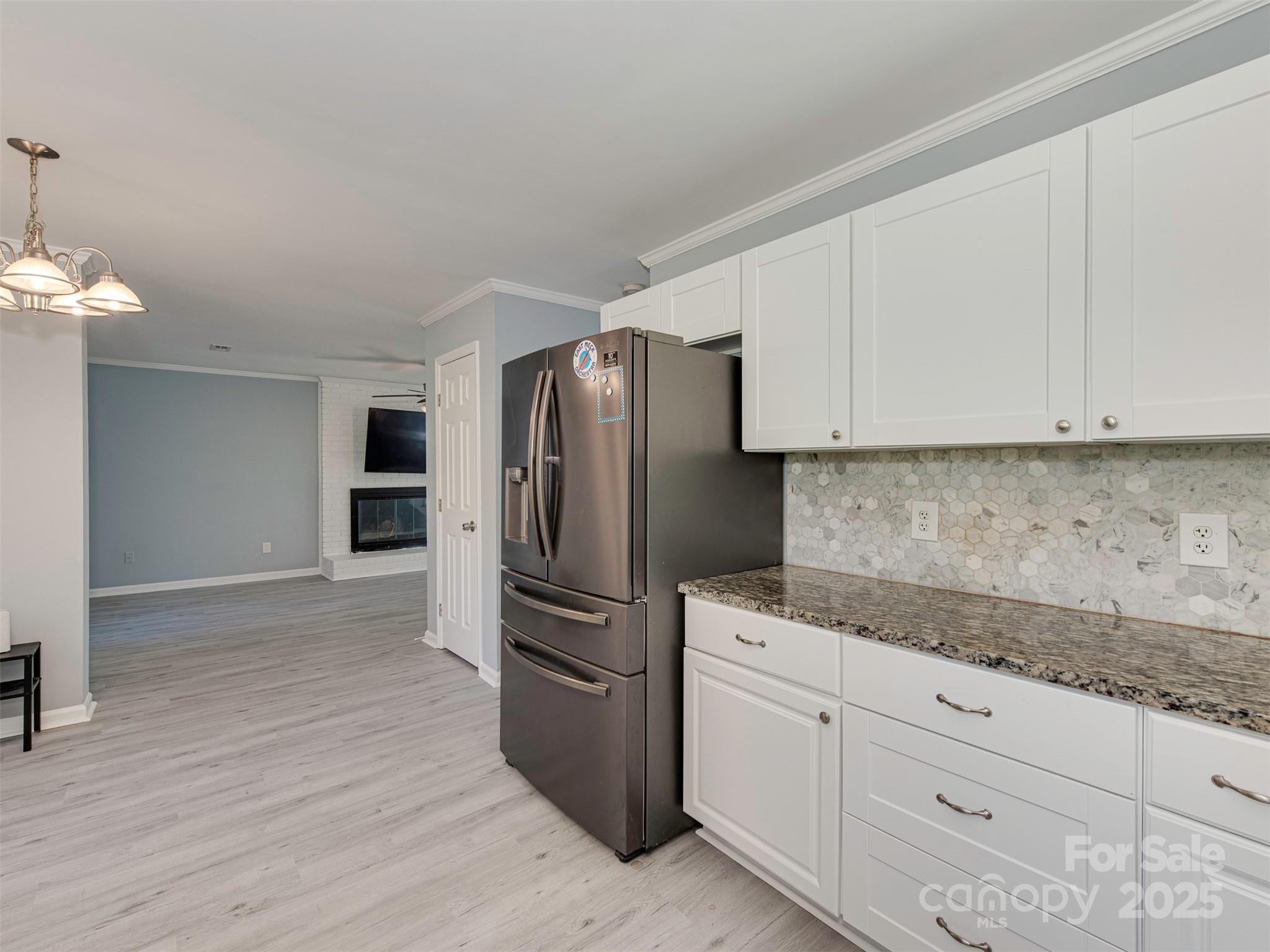 7413 Lockmont Drive Charlotte, NC 28212 - Photo 16 of 42 a kitchen with granite countertop white cabinets and stainless steel appliances