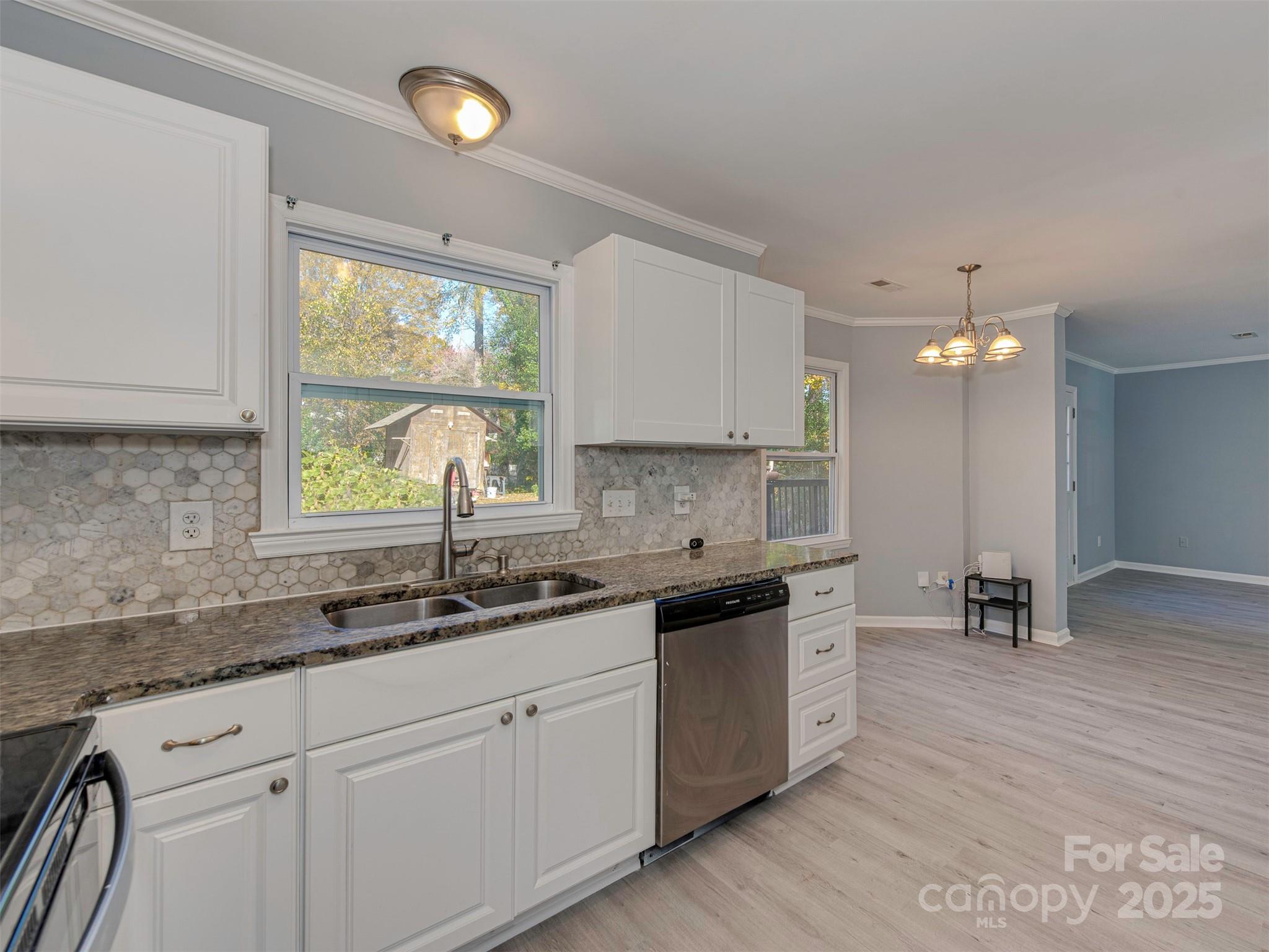 7413 Lockmont Drive Charlotte, NC 28212 - Photo 17 of 42 a kitchen with a sink stove and cabinets