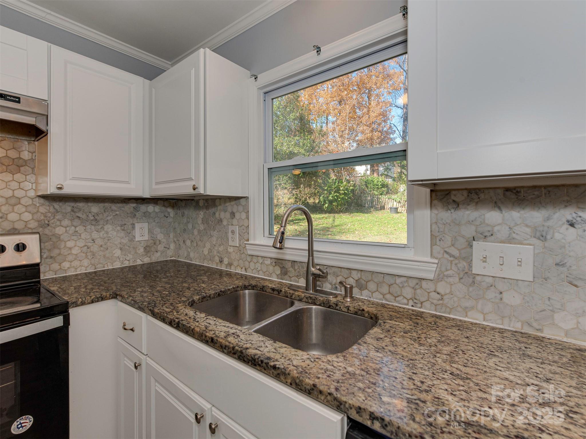 7413 Lockmont Drive Charlotte, NC 28212 - Photo 18 of 42 a kitchen with a sink cabinets and window