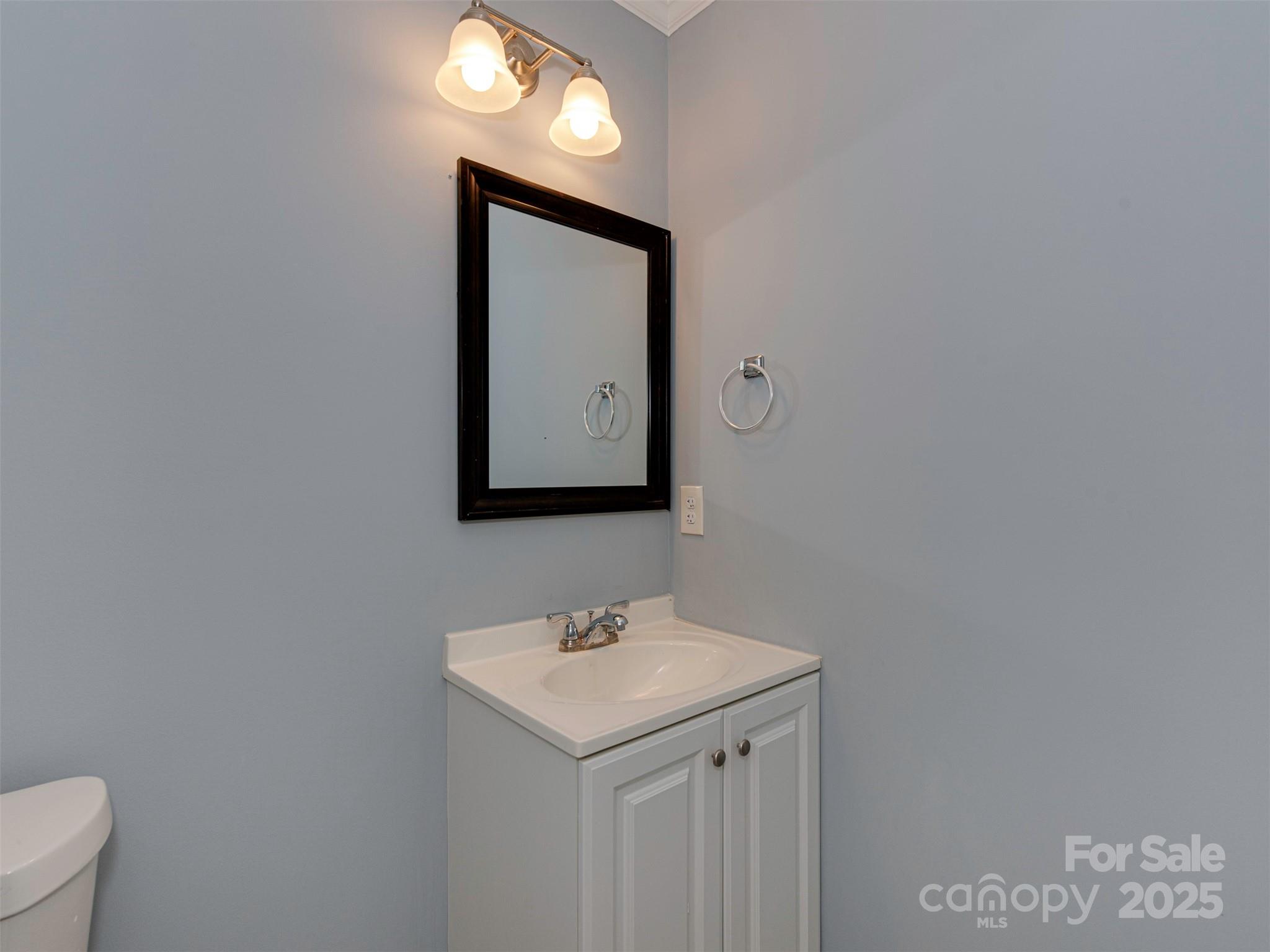7413 Lockmont Drive Charlotte, NC 28212 - Photo 21 of 42 a bathroom with a toilet sink and mirror