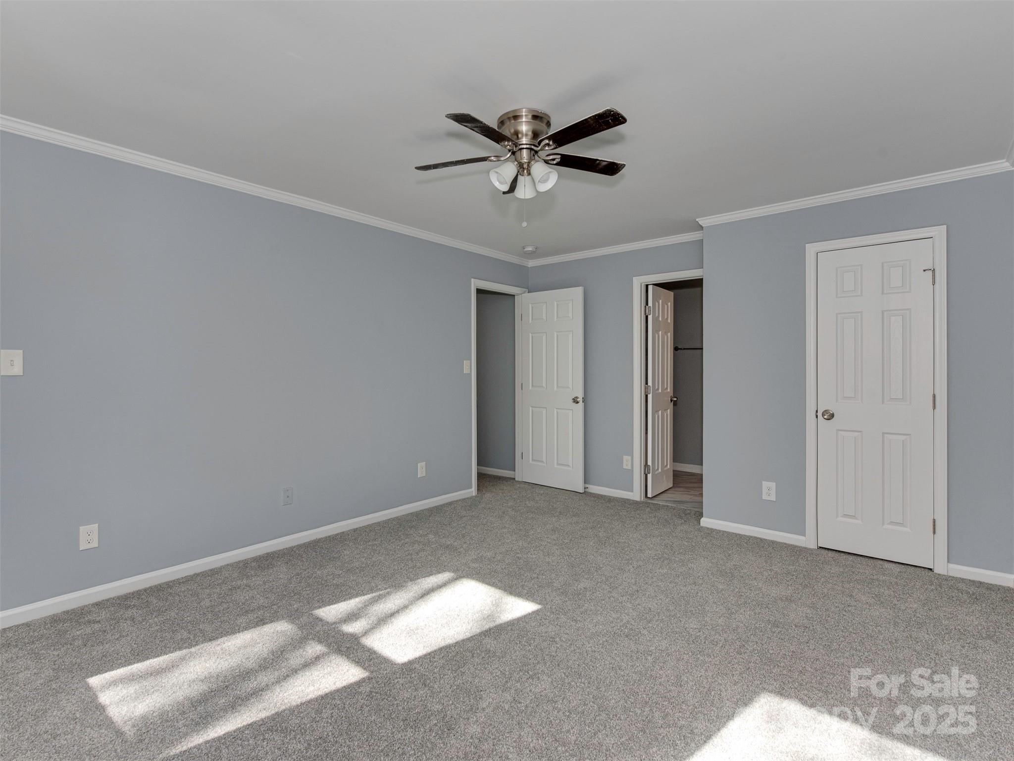7413 Lockmont Drive Charlotte, NC 28212 - Photo 24 of 42 a view of a livingroom with a ceiling fan & cabinetry