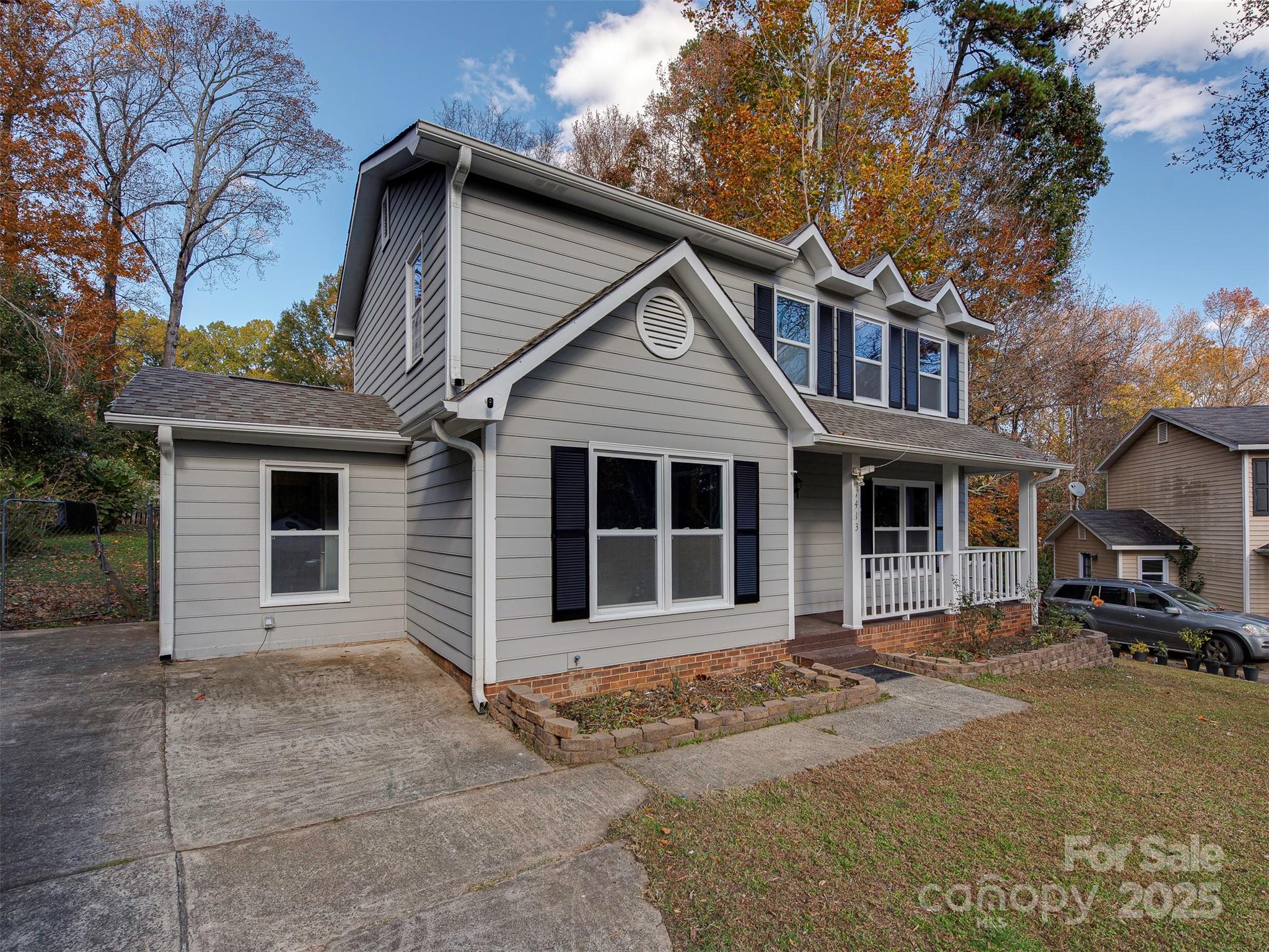 7413 Lockmont Drive Charlotte, NC 28212 - Photo 3 of 42 a front view of a house with a yard and garage
