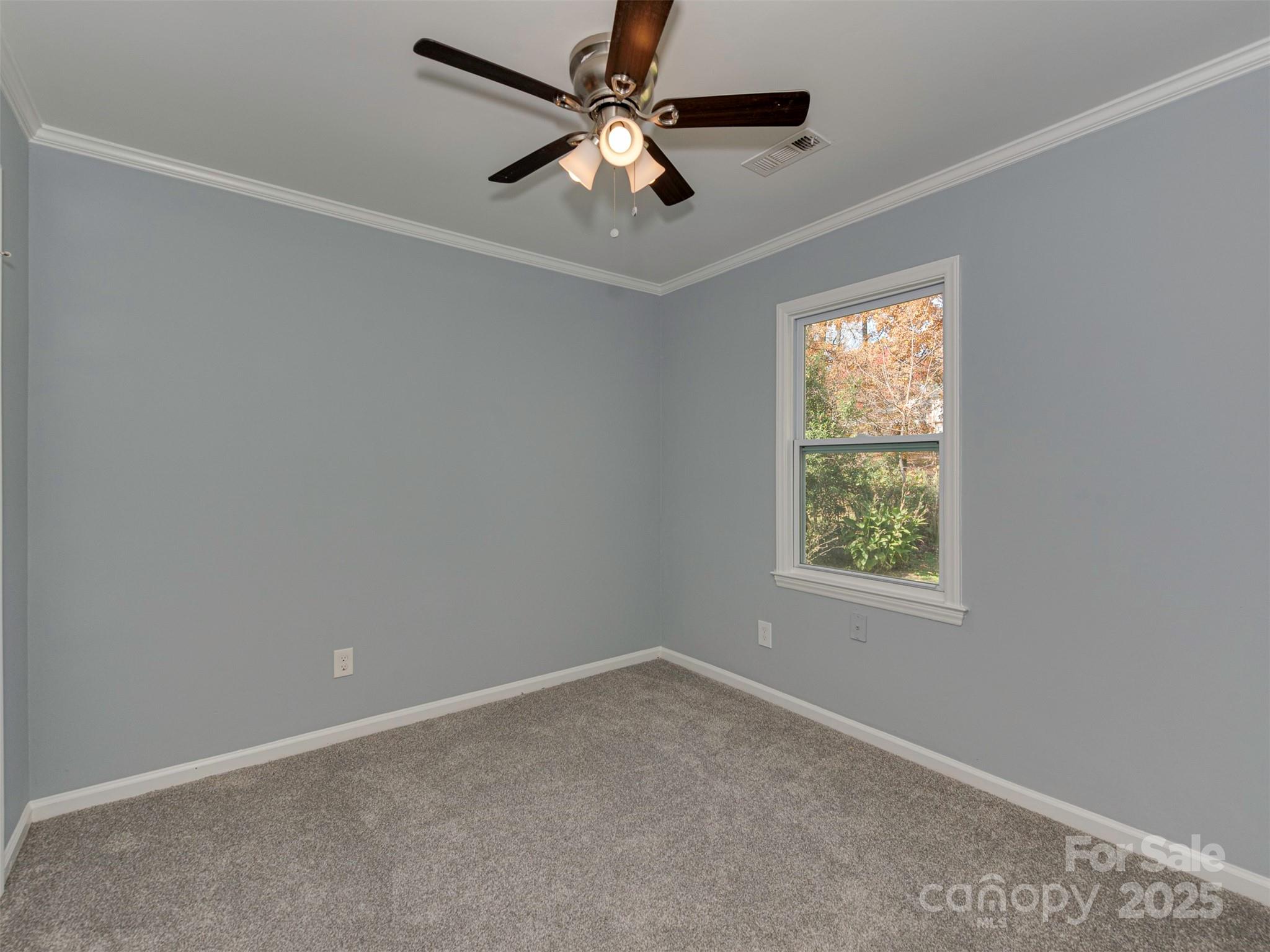 7413 Lockmont Drive Charlotte, NC 28212 - Photo 32 of 42 an empty room with a window and a fan