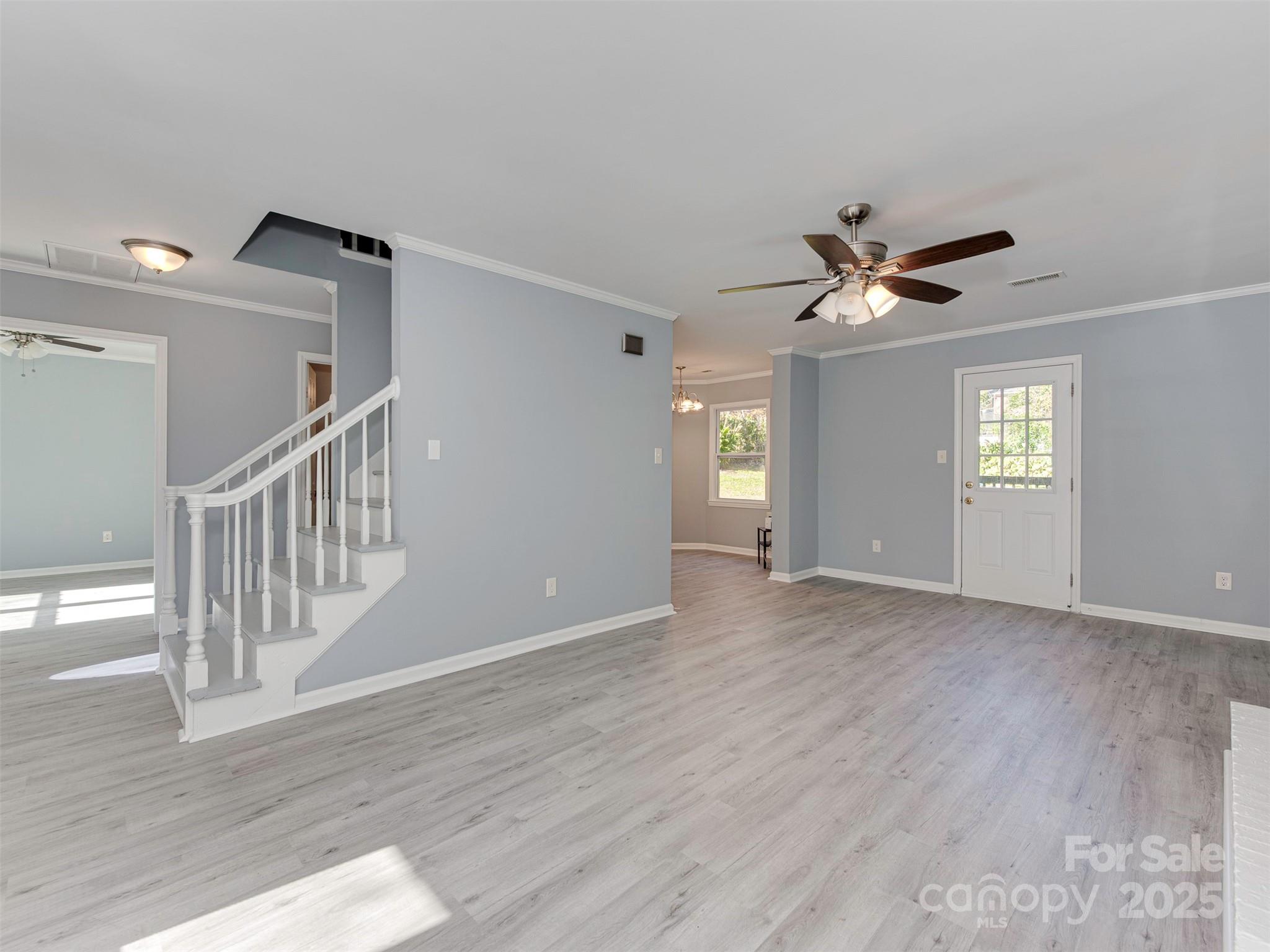 7413 Lockmont Drive Charlotte, NC 28212 - Photo 9 of 42 a view of an empty room with a window and wooden floor