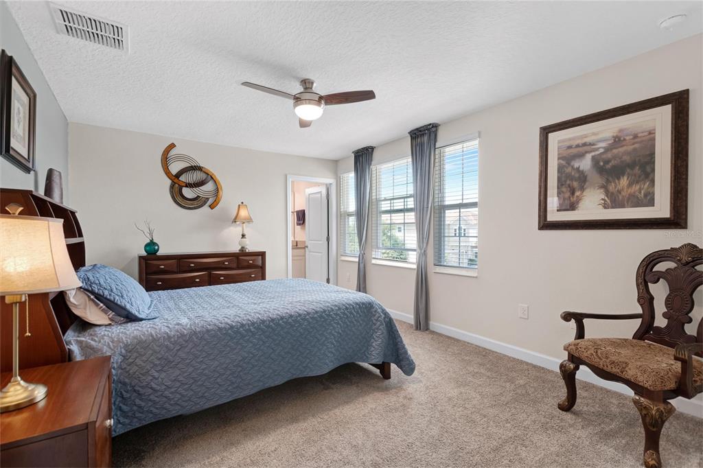 1089 Blackwolf Run Road Davenport, FL 33896 - Photo 30 of 82 a bedroom with a bed and a chair