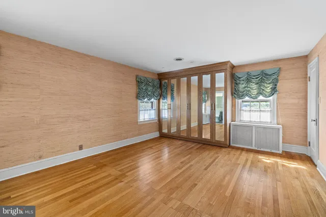 a view of a room with wooden floor and white walls