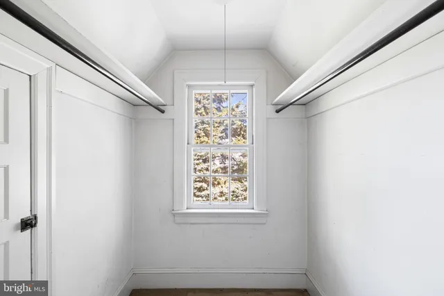a living room with furniture a fireplace and a large window