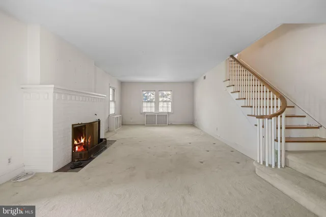 a kitchen with kitchen island granite countertop a sink window and cabinets