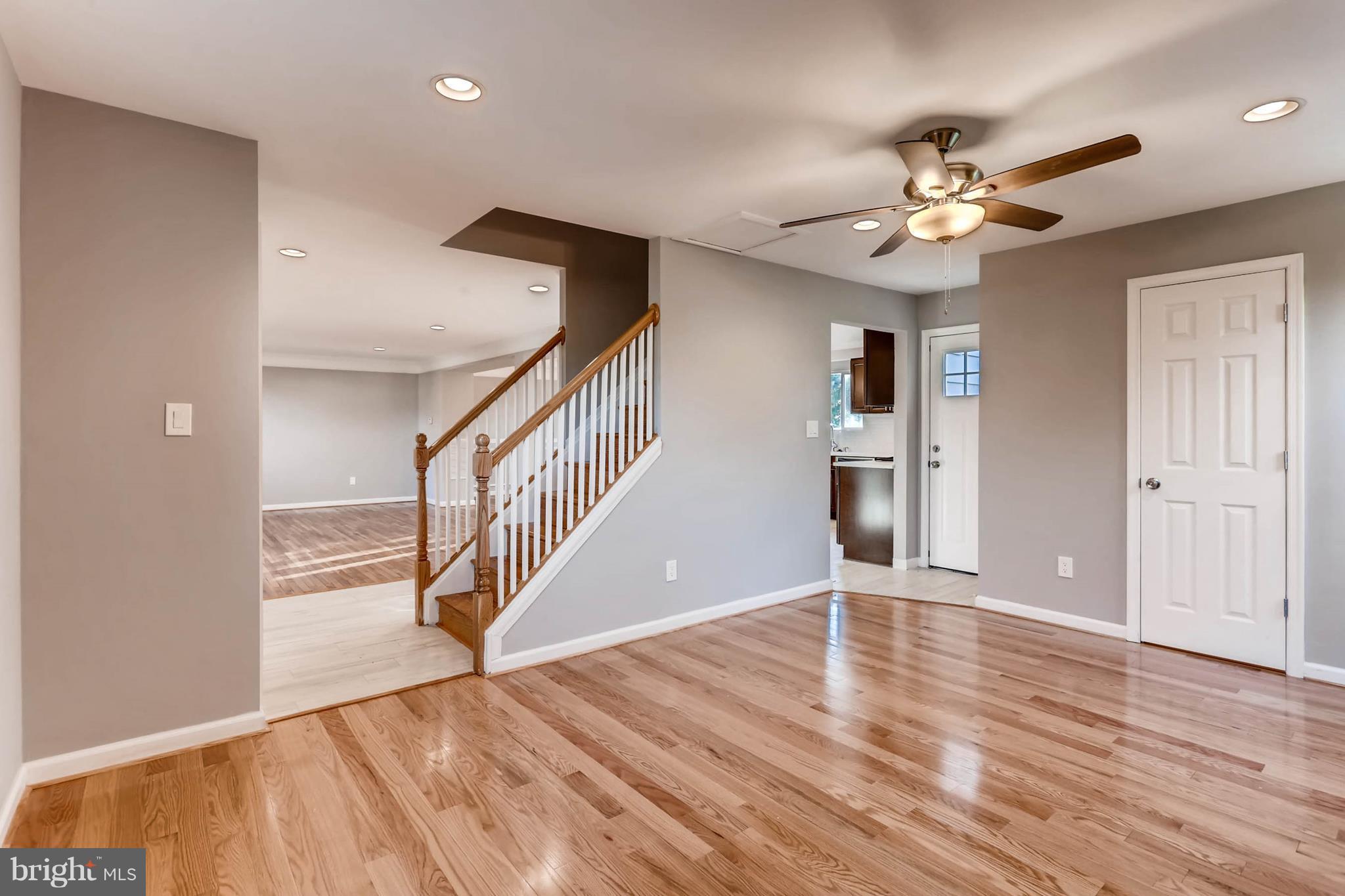3935 Nemo Road Randallstown, MD 21133 - Photo 4 of 23 a view of an empty room with wooden floor and a ceiling fan