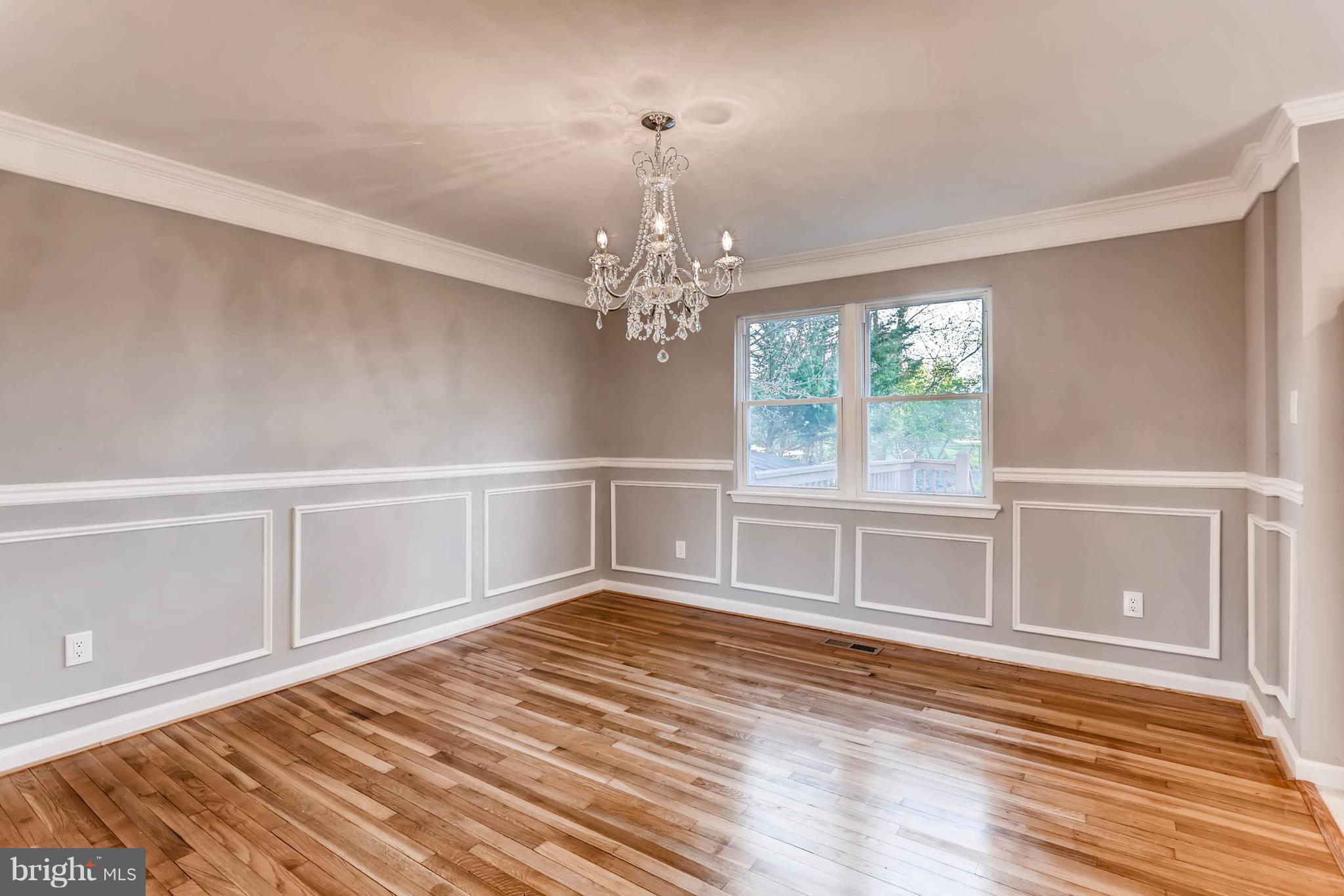 3935 Nemo Road Randallstown, MD 21133 - Photo 6 of 23 a view of an empty room with wooden floor and a window