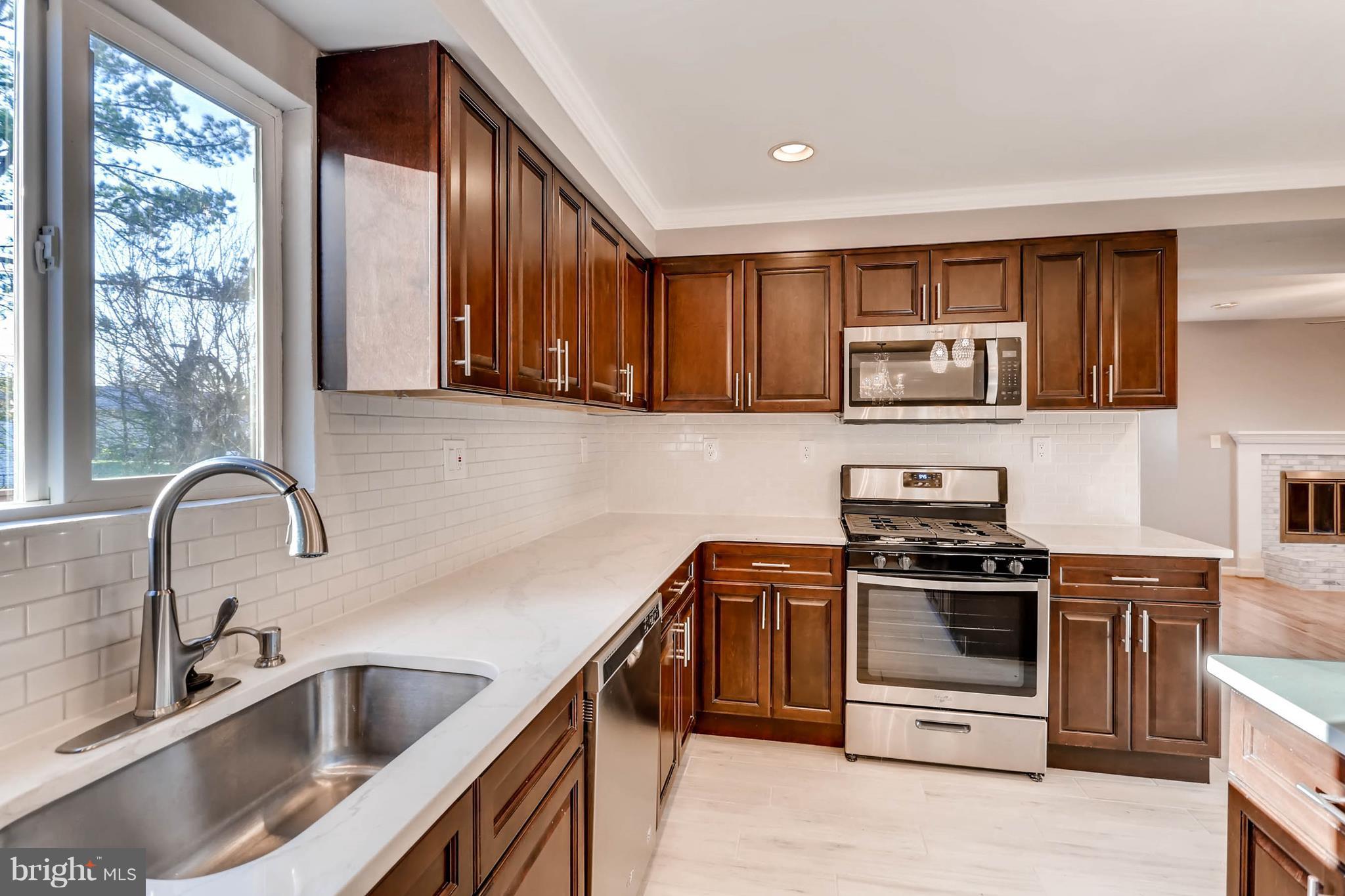 3935 Nemo Road Randallstown, MD 21133 - Photo 8 of 23 a kitchen with stainless steel appliances a sink a stove and cabinets