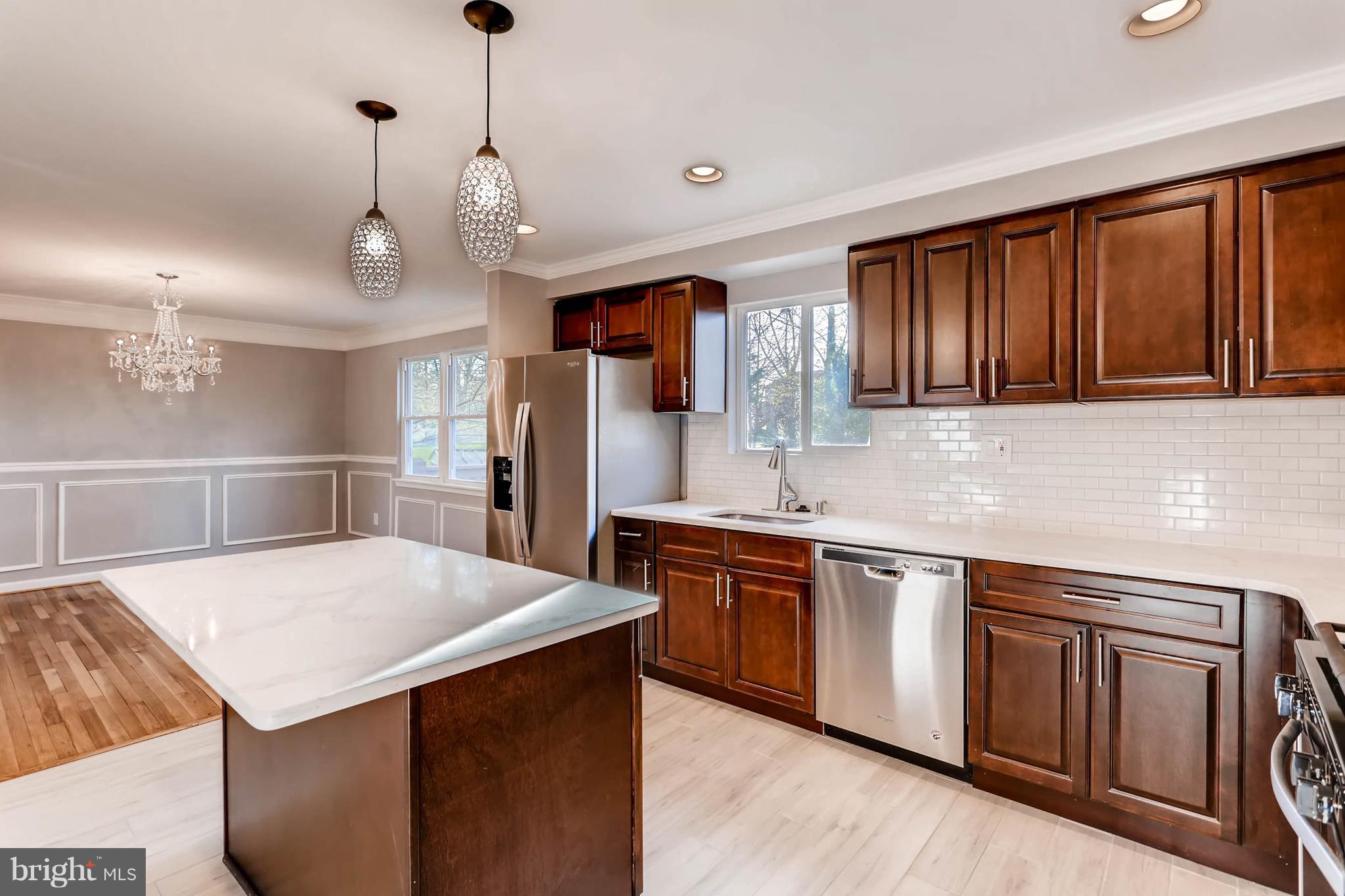 3935 Nemo Road Randallstown, MD 21133 - Photo 9 of 23 a kitchen with stainless steel appliances granite countertop a sink a stove a refrigerator cabinets and wooden floor