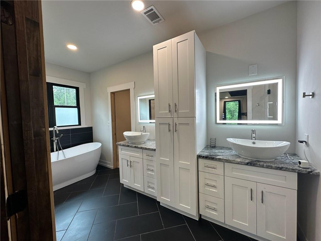 1001 Bailey Road Rome, GA 30161 - Photo 17 of 44 a bathroom with a granite countertop sink and a mirror
