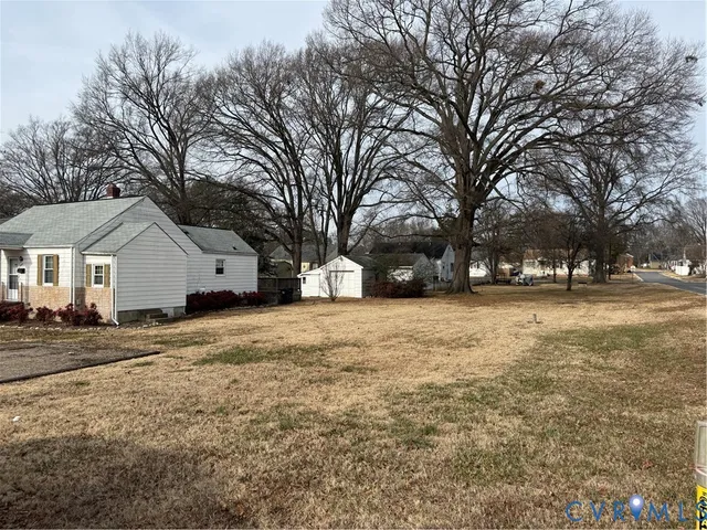 a front view of house with yard and trees