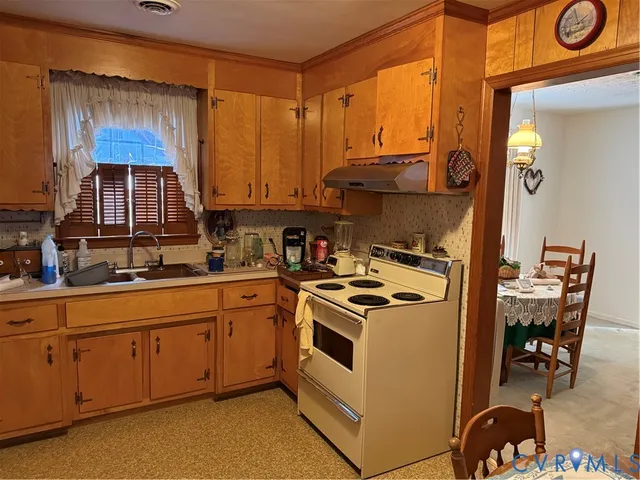 a kitchen with a stove a sink and a microwave