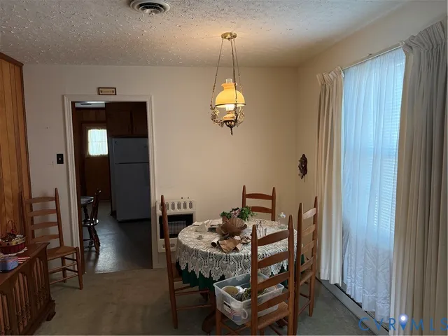 a dining room with furniture and window