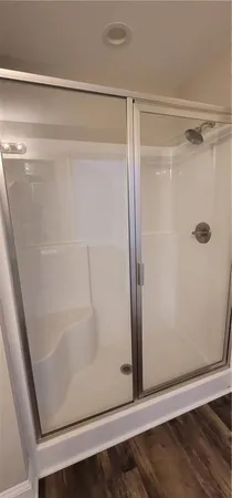 a bathroom with a granite countertop toilet sink and mirror