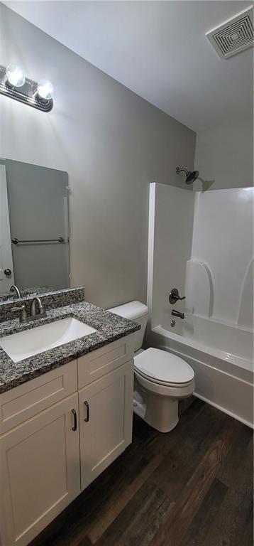 123 Ridge Crest Court Ellijay, GA 30540 - Photo 19 of 34 a bathroom with a granite countertop toilet sink and mirror