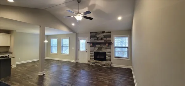 a kitchen with stainless steel appliances granite countertop white cabinets a sink a stove and a microwave