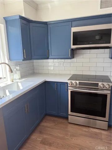 a kitchen with granite countertop a stove and a sink