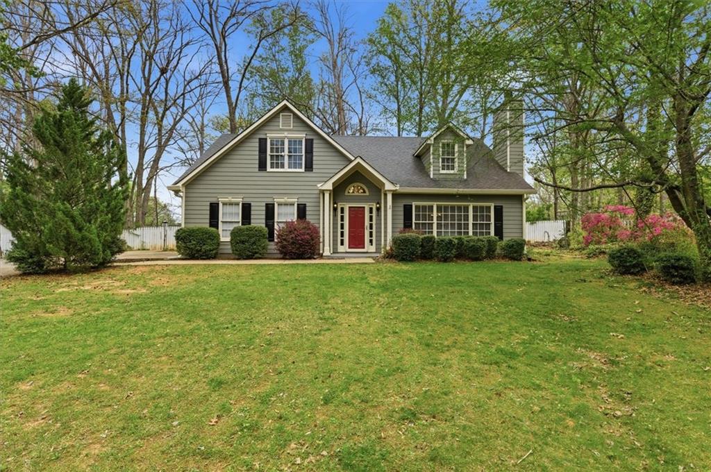 a front view of house with yard and green space