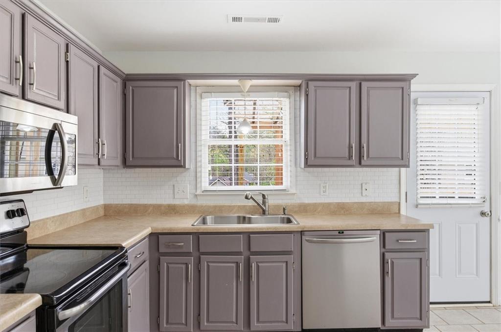 139 Stanbrough Drive Dallas, GA 30157 - Photo 16 of 52 a kitchen with granite countertop a sink stove and cabinets