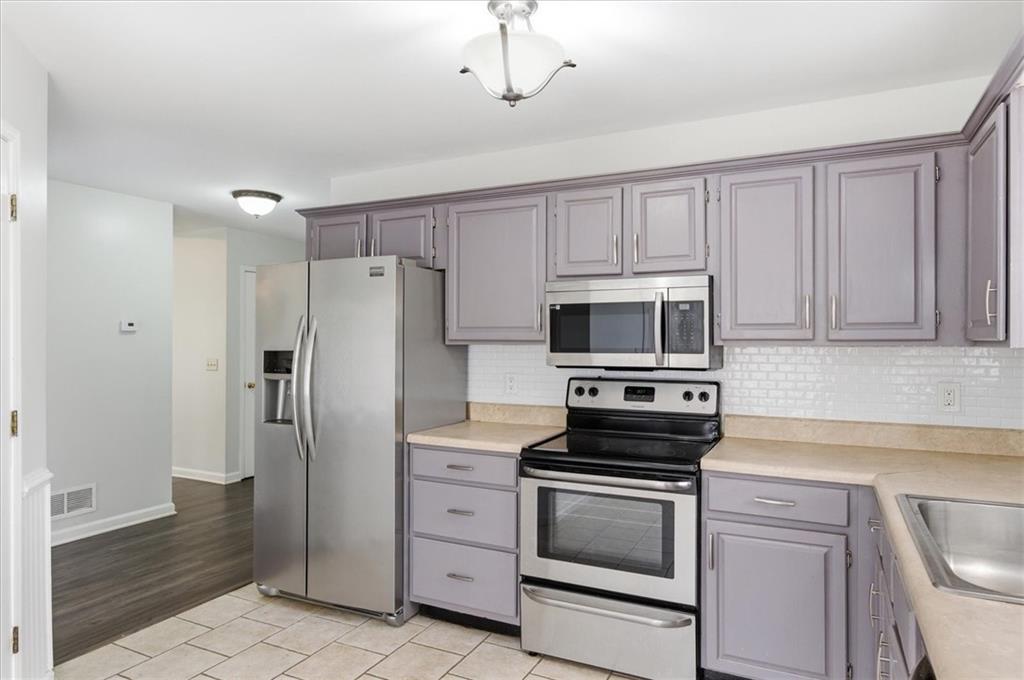 139 Stanbrough Drive Dallas, GA 30157 - Photo 19 of 52 a kitchen with cabinets stainless steel appliances and a counter space