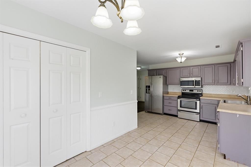 139 Stanbrough Drive Dallas, GA 30157 - Photo 22 of 52 a kitchen with cabinets and stainless steel appliances