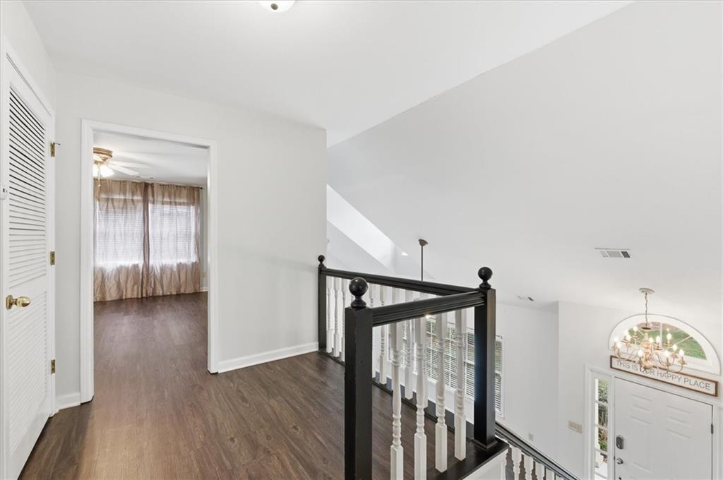 139 Stanbrough Drive Dallas, GA 30157 - Photo 25 of 52 a view of a hallway to a livingroom with wooden floor and stairs