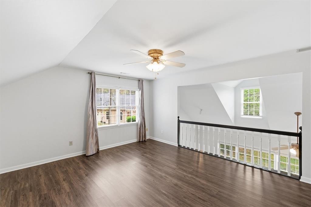 139 Stanbrough Drive Dallas, GA 30157 - Photo 27 of 52 an empty room with wooden floor chandelier fan and windows