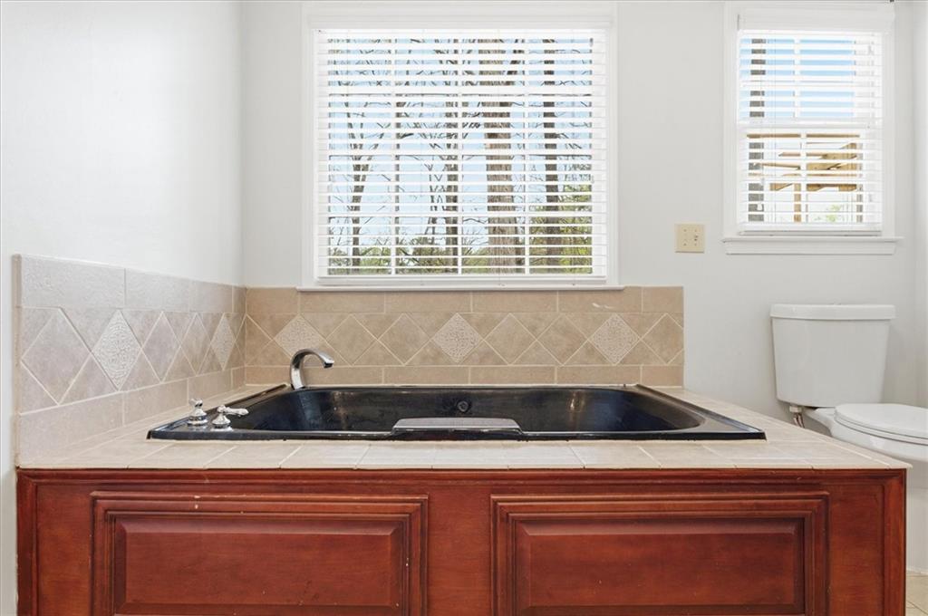 139 Stanbrough Drive Dallas, GA 30157 - Photo 39 of 52 a sink with a granite countertop white cabinets and a window