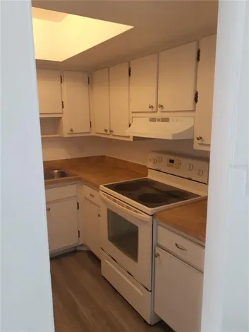 a view of a kitchen with sink and cabinets