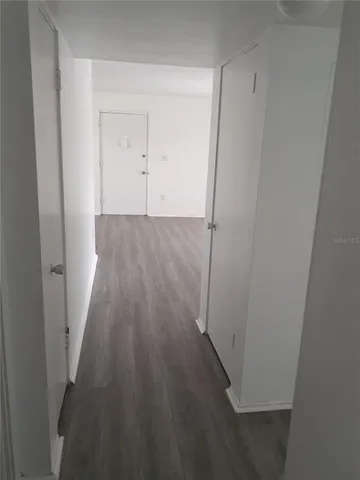 a view of a room with wooden floor