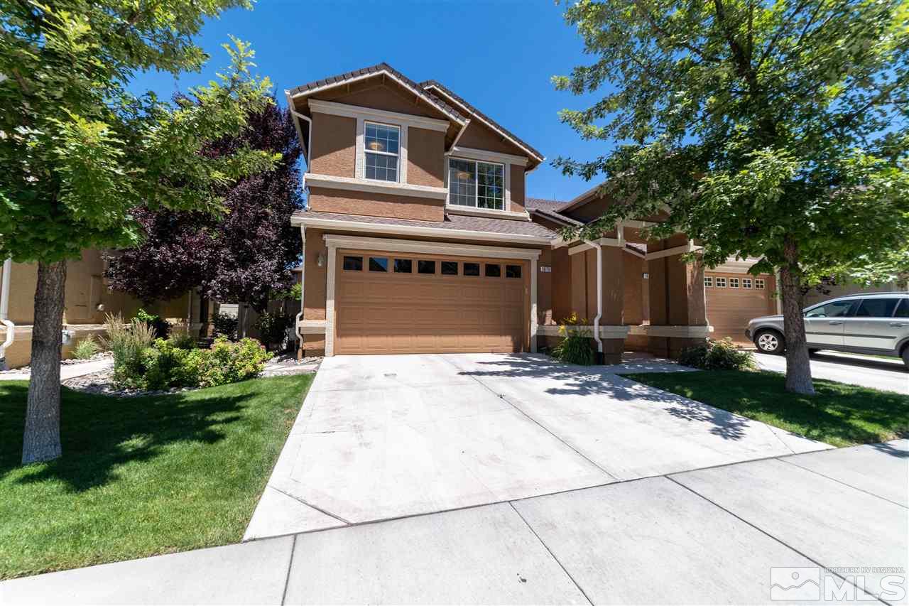 1875 Stetson Drive Reno, NV 89521 - Photo 1 of 27 a front view of a house with a yard and garage