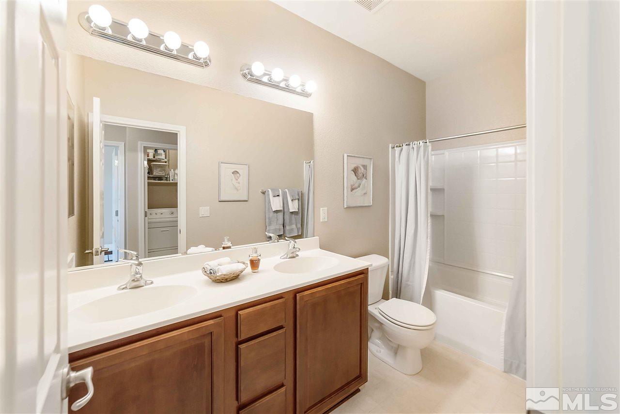 1875 Stetson Drive Reno, NV 89521 - Photo 23 of 27 a bathroom with a sink a toilet a mirror and shower