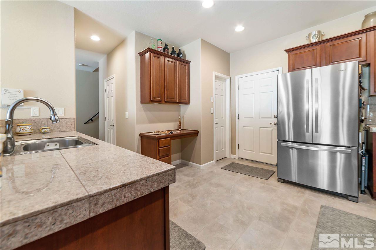 1875 Stetson Drive Reno, NV 89521 - Photo 10 of 27 a kitchen with refrigerator and microwave