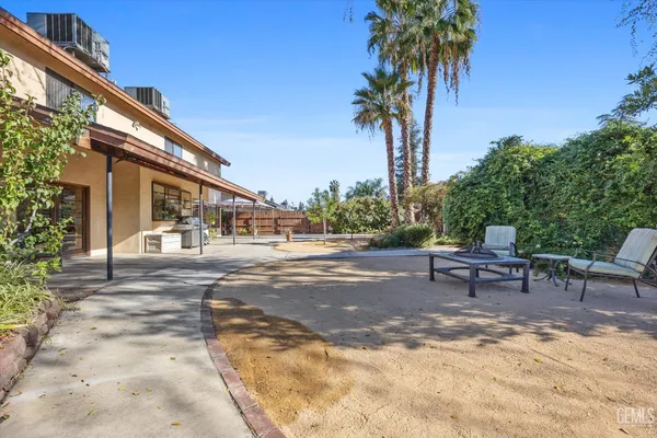 a dining room with furniture and a floor to ceiling window