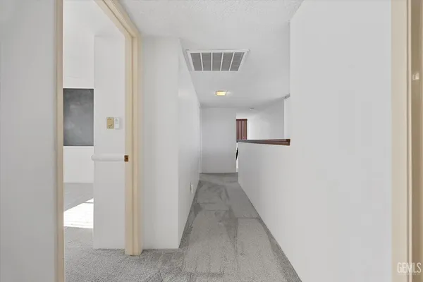 a view of a patio with table and chairs and floor to ceiling window