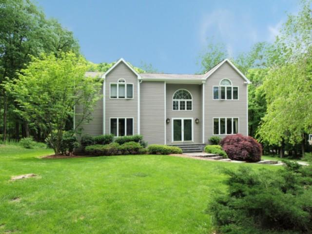 90 Nursery Road Ridgefield, CT 06877 - Photo 1 of 1 a front view of a house with a yard and garage