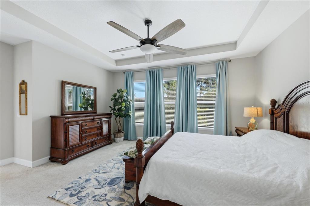 9268 Tequila Sunrise Drive Sarasota, FL 34241 - Photo 20 of 56 a bedroom with a large bed and a chandelier