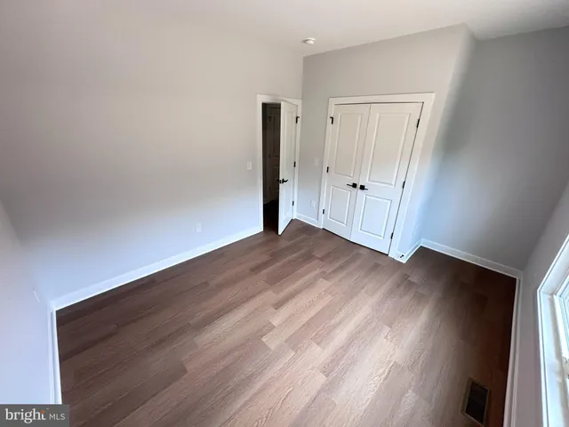 a view of a livingroom with wooden floor and window