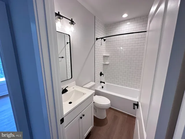 a bathroom with a tub a toilet and a sink
