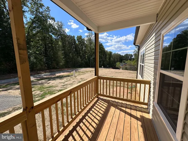 a view of balcony with wooden floor