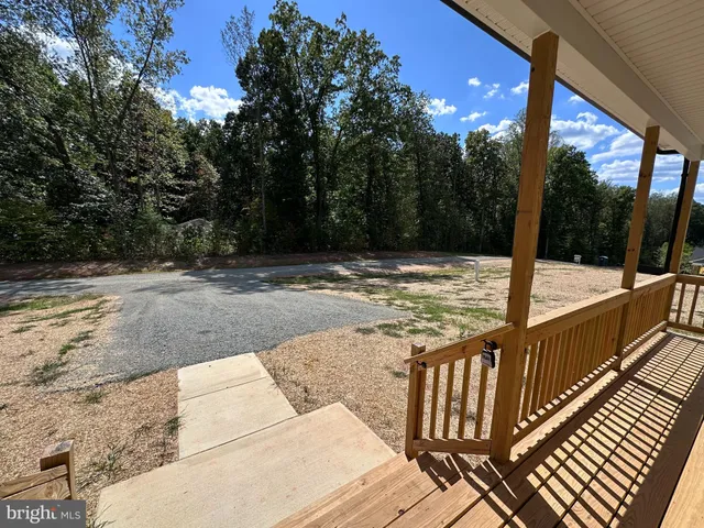 a view of a balcony with yard