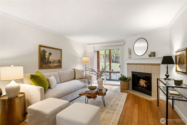 a living room with furniture fireplace and a large window