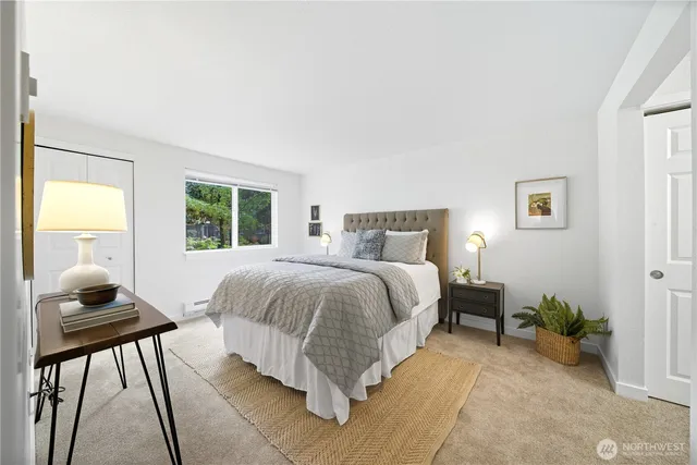 a bedroom with a bed and a window